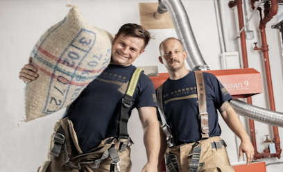 firefighters holding coffee bean bag